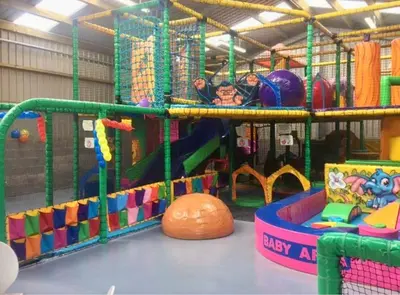 a childrens play room with a playground with many toys at Loch View 28 in Stranraer