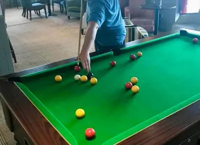 a man playing pool on a pool table at Loch View 28 in Stranraer