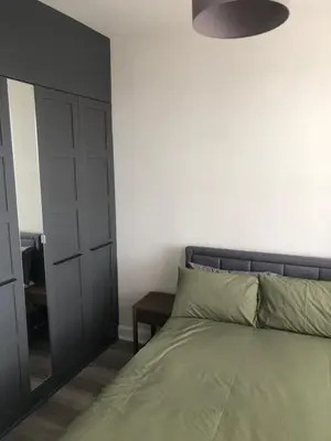 a bedroom with a bed and a mirror at Charming West End Flat in Edinburgh