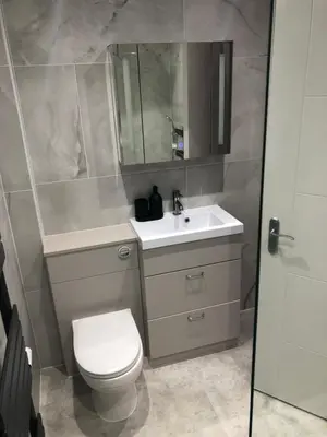 a bathroom with a toilet and a sink and a mirror at Charming West End Flat in Edinburgh