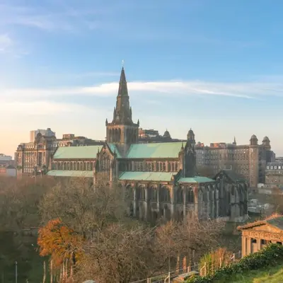 an old building with a tower and a church at Stylish Merchant City Flat Glasgow in Glasgow