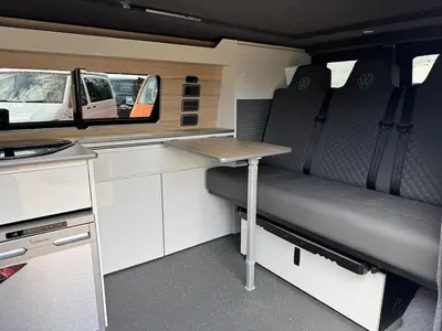 a small kitchen with a table in a caravan at Campervan Scotland, Ben Roamer in Dunblane