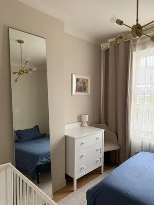 a bedroom with two beds and a mirror at Happy two bedrooms apartment in Moffat
