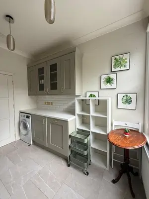 a kitchen with a table and a small table and a table at Happy two bedrooms apartment in Moffat