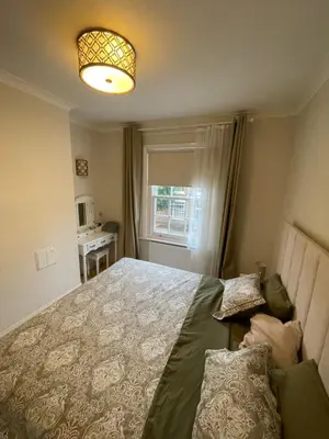 a bedroom with a large bed and a window at Happy two bedrooms apartment in Moffat