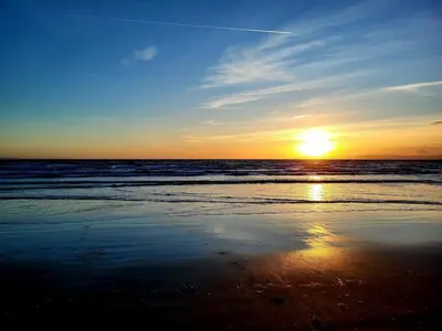 a sunset on the beach with the ocean at Ta'Pinu House and Spa in Horse Isle