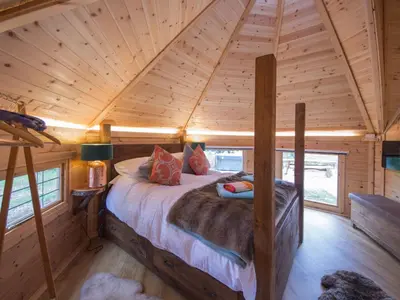 a bedroom in a log cabin with a bed at Woodcock Lodge in Kilmichael Glassary