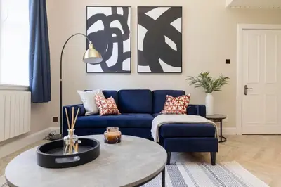 a living room with a blue couch and a coffee table at 1 bed in heart of Old Town with Castle Views in Edinburgh