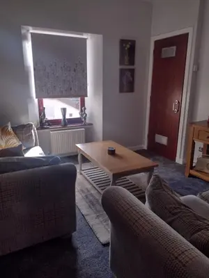 a living room with two couches and a coffee table at DRIFTWOOD coastal holiday flat - newly refurbished with 2 bedrooms in Largs