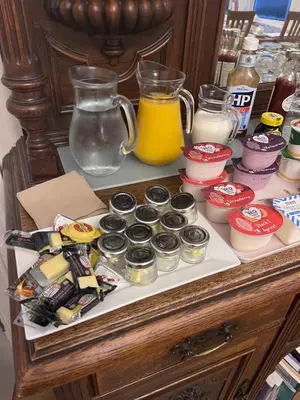a table with a bunch of desserts and a jug of juice at Ravenswood Guest House in Stirling