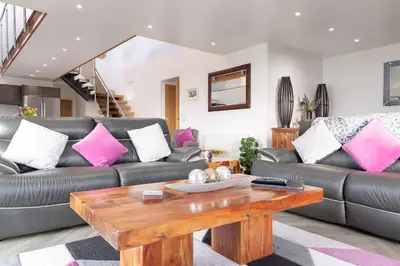 a living room with a couch and a coffee table at Sunset View in Innellan