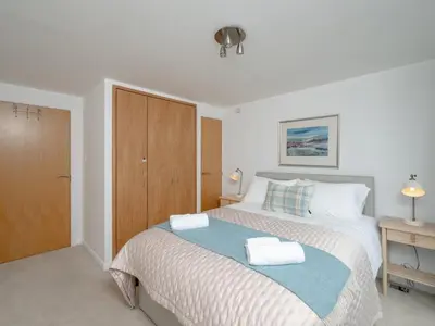 a bedroom with a bed with two towels on it at Pass the Keys Spacious Bright Modern Edinburgh City Flat in Edinburgh