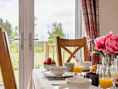 a table with food and flowers on top of it at Drovers Lodge, farm retreat in rural Lanarkshire, family and pet friendly, onsite craft distillery, perfect location for exploring central Scotland in Forth