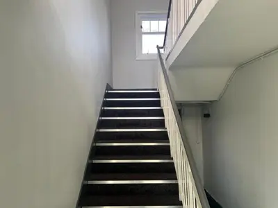 a staircase in a building with a window at Fifty Five on Gilmour Street in Eaglesham