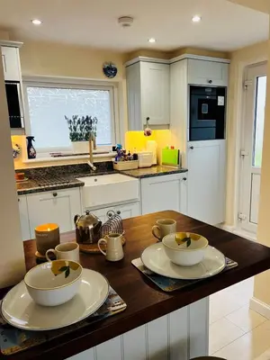 a kitchen with a wooden counter top with two bowls at Angel Cottage, Strone in Dunoon