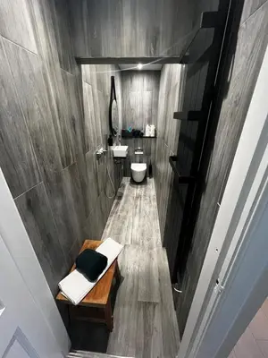 a bathroom with two sinks and a toilet at Angel Cottage, Strone in Dunoon