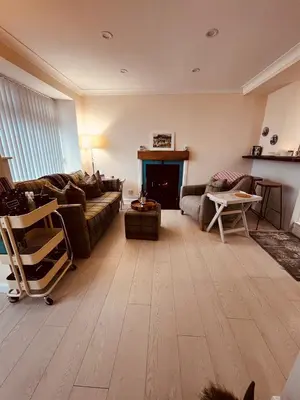 a living room with a couch and a table at Angel Cottage, Strone in Dunoon