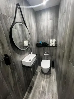 a bathroom with a sink and a toilet and a mirror at Angel Cottage, Strone in Dunoon