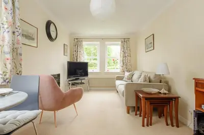 a living room with a couch and a tv at Lovely Edinburgh Home - Craighouse Gardens in Edinburgh