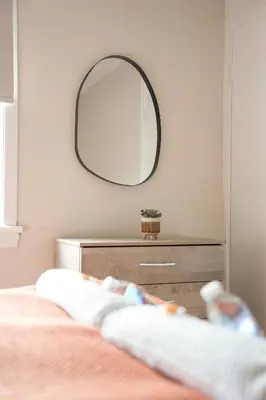 a bedroom with a dresser and a mirror at 4 BDR House By Caledonia Luxe Stays Short Lets & Serviced Accommodation Livingston in Livingston