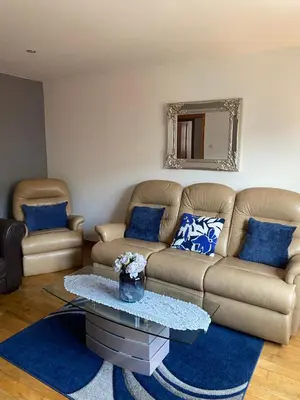 a living room with a couch and a table at Number one faraline in Moffat