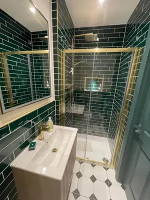 a bathroom with a sink and a glass shower at Fordells Lodgings Stylish Rooms in Historic Townhouse in Inverkeithing