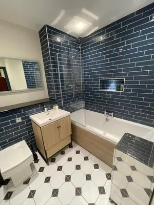 a bathroom with a tub and a sink and a toilet at Fordells Lodgings Stylish Rooms in Historic Townhouse in Inverkeithing