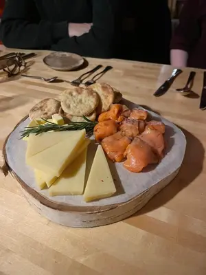 a plate of food with cheese and other foods on a table at Fordells Lodgings Stylish Rooms in Historic Townhouse in Inverkeithing