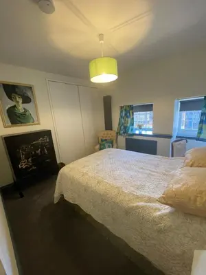 a bedroom with a bed and a yellow light at Fordells Lodgings Stylish Rooms in Historic Townhouse in Inverkeithing