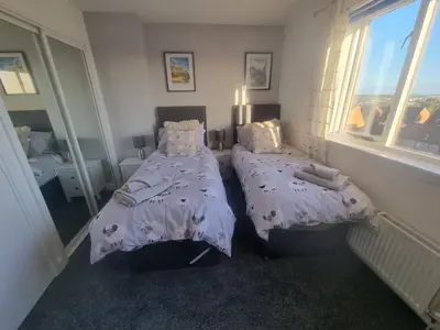 a bedroom with two twin beds and a window at Cheerful two bedroom home in Dunfermline in Dunfermline