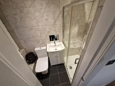a bathroom with a sink and a toilet and a shower at Edinburgh West Luxury 5 Bedroom Home in Edinburgh