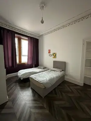 a bedroom with two beds and a window at Victorian 5 Bedroom House Free Parking SSE Central in Glasgow