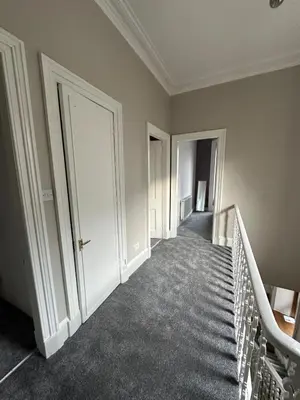 an empty hallway with stairs and doors in a building at Victorian 5 Bedroom House Free Parking SSE Central in Glasgow