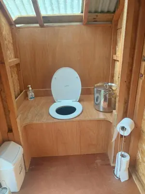 a bathroom with a toilet in a tiny house at Shepherd's Hut Harmony at A Therapeutic Space in Moniaive