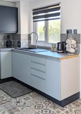 a kitchen with a counter with a sink and a window at Fairway house in Campbeltown