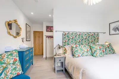 a bedroom with a bed and a blue dresser at Blà Bheinn by Birch Stays in Dunollie