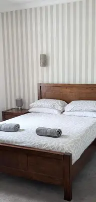 a bed with two pillows on top of it at Whisky Row in Campbeltown