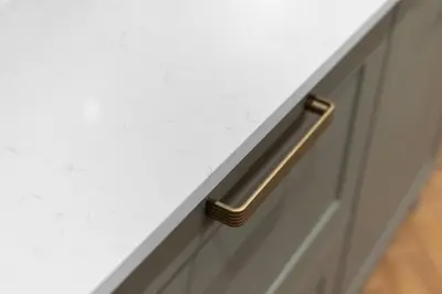 a drawer with a gold handle on a white cabinet at The Kings Park Luxury Residence in Stirling