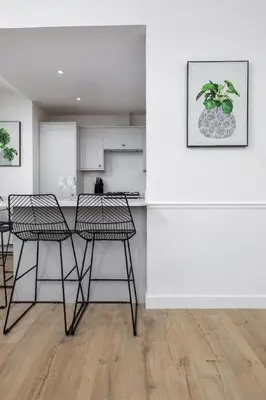 a kitchen with chairs and a counter in a room at The Stirling Penthouse - Free Parking in Stirling