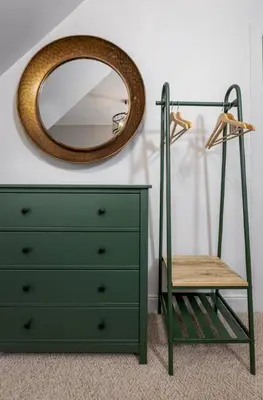 a mirror and a chair next to a dresser at Ledi Lookout Callander in Stirling