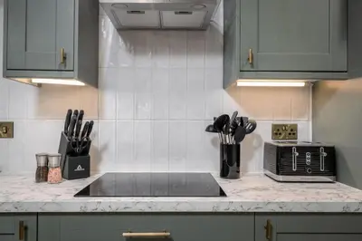 a kitchen counter with a sink and utensils at Ledi Lookout Callander in Stirling