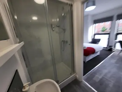 a bathroom with a shower and a toilet in a room at Fishpond Family Suite in Moffat