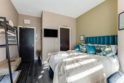 a bedroom with a bed and a bunk bed at Stylish Studio Retreat in Ideal Location in Moffat