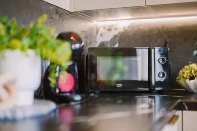 a microwave sitting on top of a counter at JW Executive ApartHouse in Glasgow