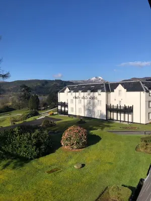 an aerial view of a large white building at Macdonald Forest Hills Resort in Aberfoyle