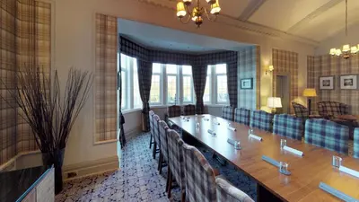 a conference room with a long table and chairs at Macdonald Forest Hills Resort in Aberfoyle