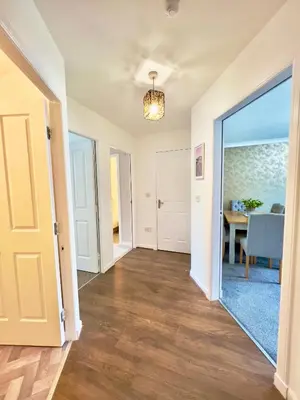 an empty hallway of a home with a dining room at Stylish City Apartment with Free Parking near Town in Glasgow
