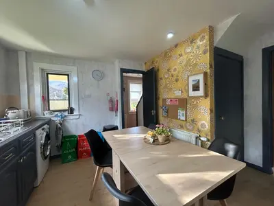 a kitchen with a table and a dining room at 29 Carnoch, Glencoe Village in Glencoe