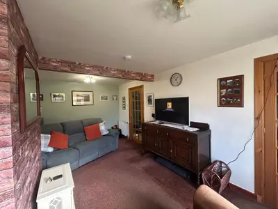 a living room with a couch and a tv at 29 Carnoch, Glencoe Village in Glencoe