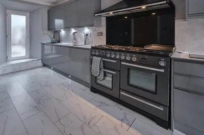 a kitchen with a stove and a counter top at Stay Torrance-Village Home Near Glasgow in Glasgow